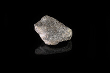 Natural Mineral Rock Specimen - Raw Arsenopyrite Stone On Black Glass Background From Kachkarskoe, Ural, Russia.