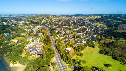 Wall Mural - Motorway running through a quiet suburb on the shore of a beautiful harbor. Auckland, New Zealand.