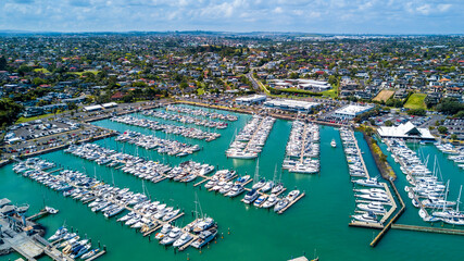 Wall Mural - Aerial view on a marina with a residential suburb in the background. Auckland, New Zealand.