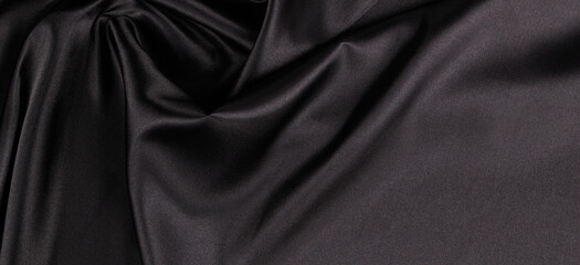 Wall Mural - Beautiful elegant black background with drapery and wavy folds of silk satin material texture. Top view
