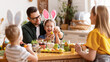 © JenkoAtaman - Happy easter! family mother, father and children paint eggs for holiday