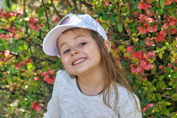 Portrait of a cheerful little girl in nature