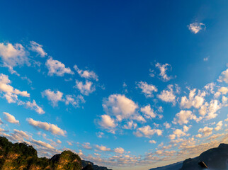 Blue sky fluffy white clouds on summer season bright clear skyline with beautiful cloudscape. Panorama blue sky clouds pattern on daylight with copy space. Cumulus cloudscape air climate sunny day