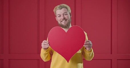 Poster - Handsome man with red heart on color background