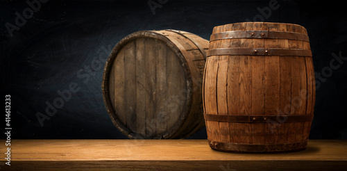 Obraz Dibond Old wooden barrel on a brown background