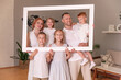 © fasli - family holding picture frame and smiling