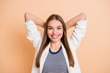 Poster - Photo of charming young girl arms behind head white shiny smile wear white jacket isolated pastel beige color background