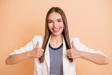 Poster - Photo of promoter girl raise thumb up toothy smile wear white blazer isolated pastel beige color background