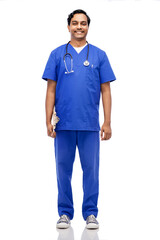 healthcare, profession and medicine concept - happy smiling indian doctor or male nurse in blue uniform with clipboard and stethoscope over white background