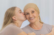 © Bangkok Click Studio - A young and beautiful daughter kiss her mother cancer patient and fortifies her to fight during the chemotherapy. Concept for love and support from beloved and family to breast cancer people