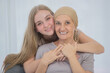 © Bangkok Click Studio - A young and beautiful daughter cuddles her mother's cancer patient and fortifies her to fight during the chemotherapy. Concept for love and support from beloved and family to breast cancer people