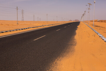 Road in the sahara desert of Egypt. Conceptual for freedom, enjoying the journey. Empty road. Freeway, Highway through the desert