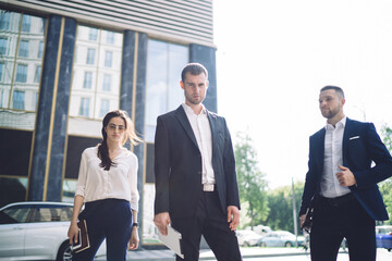 Wall Mural - Confident colleagues standing on street