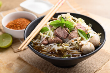 Wall Mural - Rice noodle soup with pork, pork ball and vegetables in a bowl, Thai noodles soup