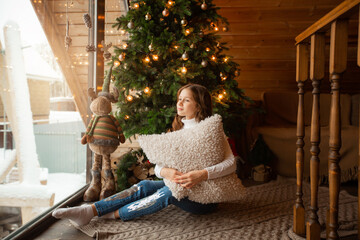 Wall Mural - beautiful teenage girl at home near christmas tree 