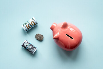 Top view of piggy bank with money coins. Savings concept