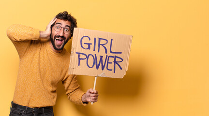 young crazy bearded man holding a girl power banner