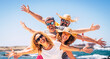 © simona - Group of happy adult friends enjoy and celebrate together the summer holiday vacation travel leisure acitivity - men and women smiling and having fun with ocean in background - joyful couples