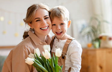 Wall Mural - grateful mother with bouquet hugging son