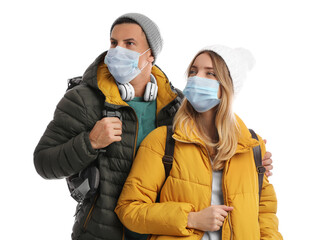 Poster - Couple in face masks and warm clothes on white background. Winter travel