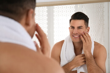 Canvas Print - Handsome man with towel near mirror in bathroom