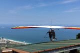 Hang glider taking off from the ramp for a double flight