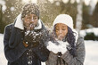 © prostooleh - People walks outside. Winter day. African couple