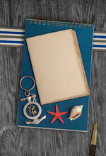 Marine Remembrances. Still Life With Notebook, Seashell, Starfish And  Pen On Wood Background.	