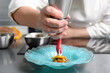 Professional chef holding a foam siphon in a restaurant kitchen. High quality photo