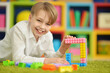 © aletia2011 - Cute little boy playing with colorful plastic blocks
