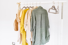 Linen Clothes On Gray Hangers On The Clothes Rack. Slow Fashion. Conscious Consumption. Crisis In The Fashion Industry, Retail. Eco-friendly, Sustainable Seasonal Sale Concept. Zero Waste.