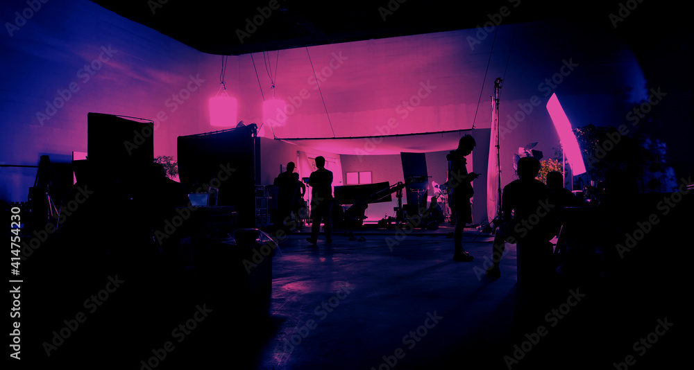 Behind the scenes of shooting video production and lighting set for filming movie which film crew team working in silhouette and professional equipment in studio for video online. video production con - obrazy, fototapety, plakaty 