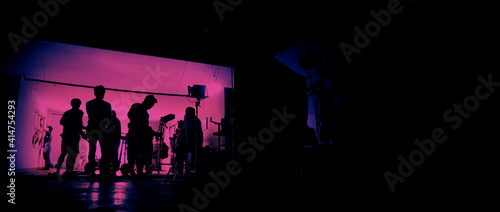 Behind the scenes of shooting video production and lighting set for filming movie which film crew team working in silhouette and professional equipment in studio for video online. video production con © gnepphoto