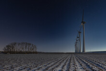 Dutch Rural Landscape With Windturbines And Fields Covered With Snow