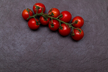 Red cherry tomato on a stone background