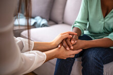 African Psychologist Hold Hands Of Girl Patient, Close Up. Teenage Overcome Break Up, Unrequited Love. Abortion Decision. Psychological Therapy, Survive Personal Crisis, Individual Counselling Concept