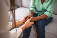 Close Up African American Psychotherapist Holding Clipboard, Touching Patient Hands, Expressing Empathy And Support At Meeting, Counselor Therapist Comforting Girl During Personal Therapy Session