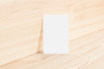 Clean business card template 85x55mm on natural wood texture background.

