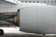 Aircraft Jet Engine turbine. Modern passenger airplane parked at the winter airport apron before departure, the view on the wing, the chassis rack gear, and engine.