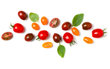 Wall Mural - various colorful tomatoes and basil leaves isolated over white background. Top view, flat lay. Creative layout..