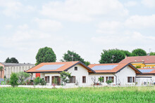 Renewable Energy System On Roof Of Traditional Houses In Contemporary Suburban Neighborhood In Italy, Europe. Modern And Beautiful Houses In European Style With Solar Panels On The Roof.