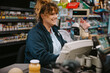 © Jacob Lund - Female cashier working on cash register in a modern supermarket