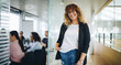 © Jacob Lund - Smiling business executive outside office boardroom