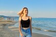 © Valerii Honcharuk - Beautiful happy female teenager 16 years old walking along sea sandy beach, at sunset