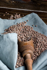 Sticker - Vertical closeup shot of lentil seeds on a gray textile