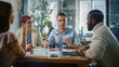 © Gorodenkoff - Office Meeting in Conference Room: Handsome Specialist Talks about Firm Strategy with Diverse Team of Professional Businesspeople. Ambitious, Creative Start-up Team Discuss Data, Design, Planning