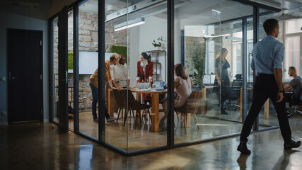 Wall Mural - In the Stylish Modern Office Meeting Room: Diverse Group of Business Growth Marketing Professionals Use Computers, Discuss Project Ideas, Brainstorm Startup Company Strategy, Design Creative Product