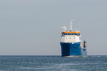 MERCHANT VESSEL - A ship with a load is traveling on a waterway
