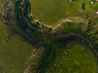 Aerial view of a green landscape with a river in the countryside