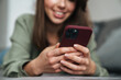© Drobot Dean - Close up of a smiling attractive woman holding mobile phone